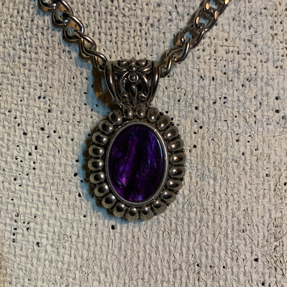 Gorgeous Purple gem inlaid in a large silver pendant